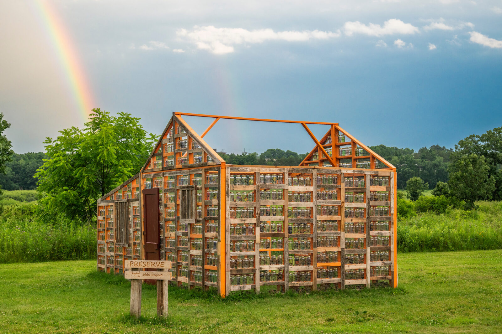 A double rainbow forms over a temporary environmental art installation at The Arboretum.