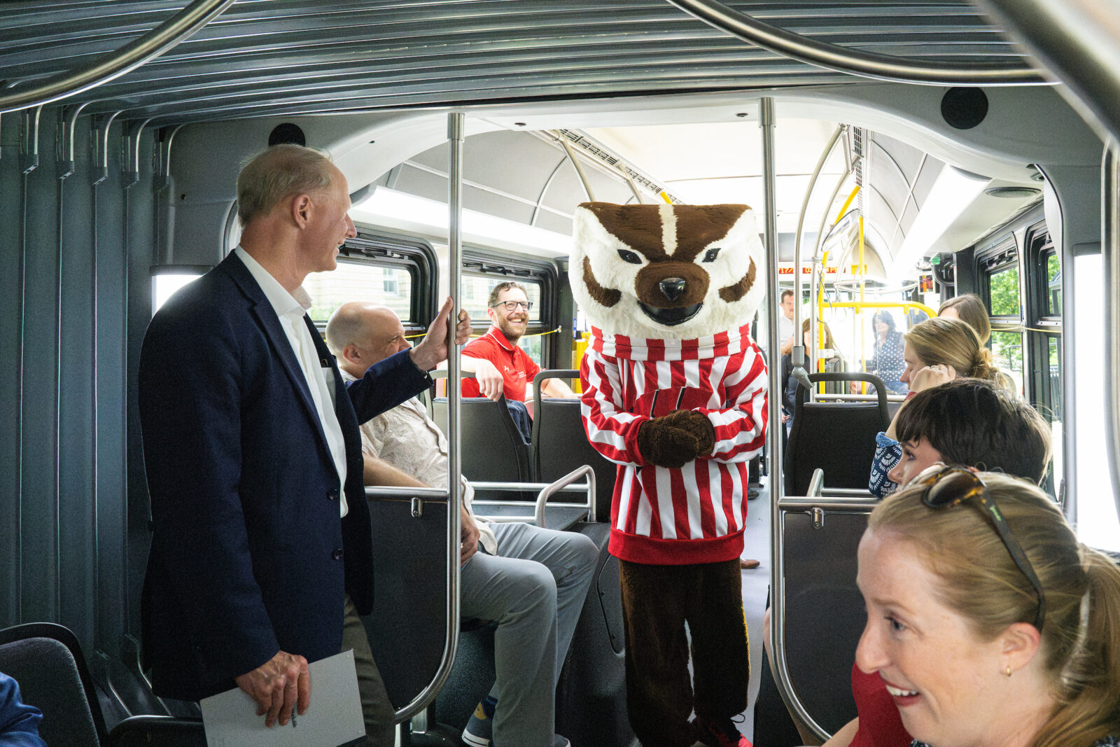 UW mascot Bucky Badger walks down the center aisle on a new 60-foot long Madison Metro electric bus as it makes a special tour around Bascom Hall at the University of Wisconsin-Madison on July 17, 2024. The new buses feature an articulated section that will allow for 50% more riders than current Madison Metro buses. (Photo by Bryce Richter / UW–Madison)