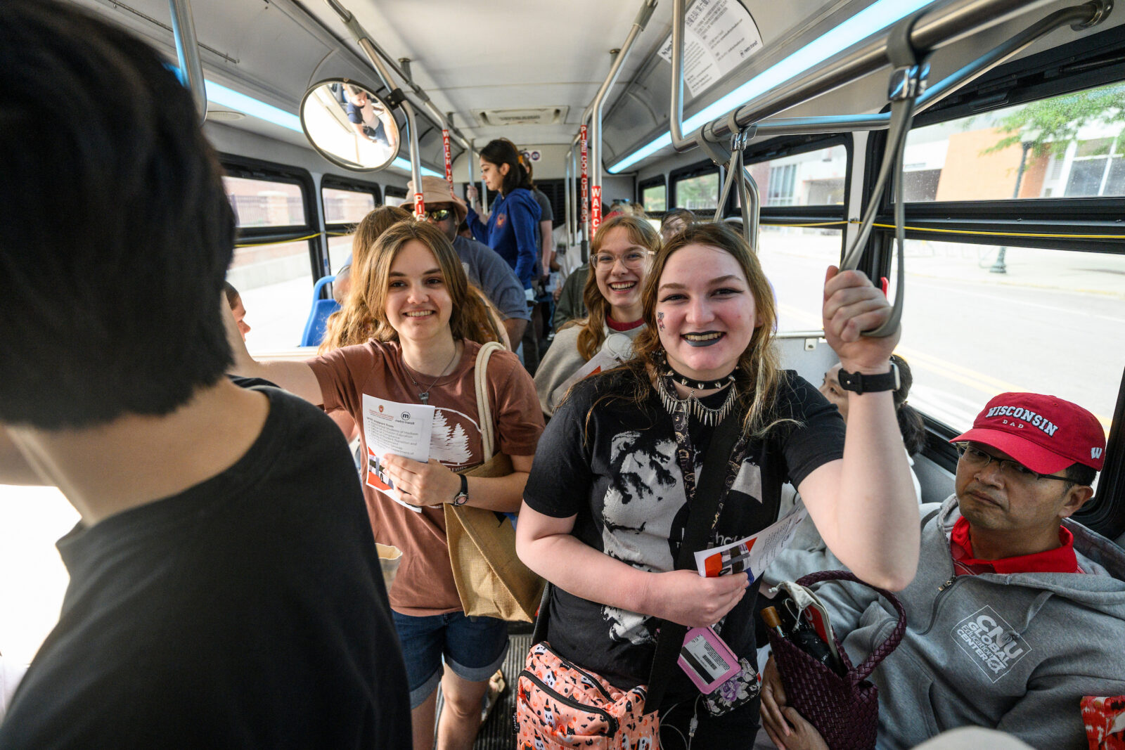 UW mascot Bucky Badger walks down the center aisle on a new 60-foot long Madison Metro electric bus as it makes a special tour around Bascom Hall at the University of Wisconsin-Madison on July 17, 2024. The new buses feature an articulated section that will allow for 50% more riders than current Madison Metro buses. (Photo by Bryce Richter / UW–Madison)