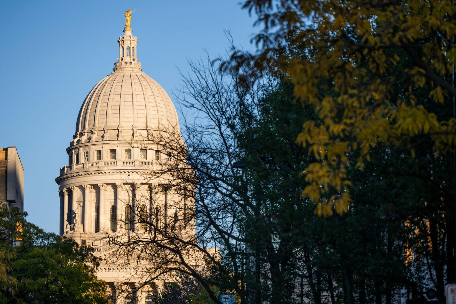 Sunset light shines on the dome of the Wisconsin State Capitol building near the University of Wisconsin–Madison campus during autumn on Oct. 17, 2024. (Photo by Jeff Miller / UW–Madison)
