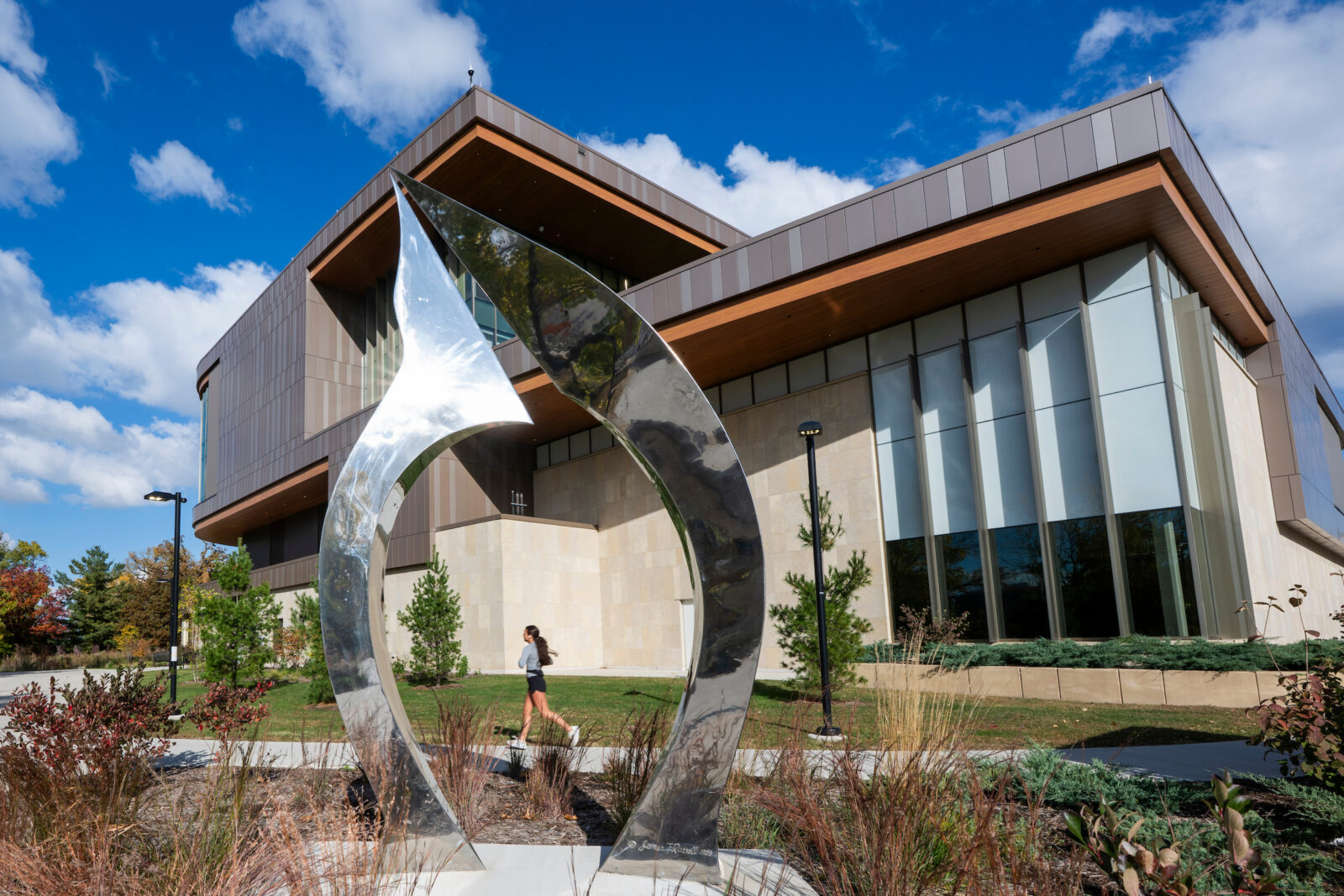 A runner passes the Bakke Recreation and Wellbeing Center on an autumn day at the University of Wisconsin–Madison on Oct. 29, 2025. (Photo by Taylor Wolfram / UW–Madison)