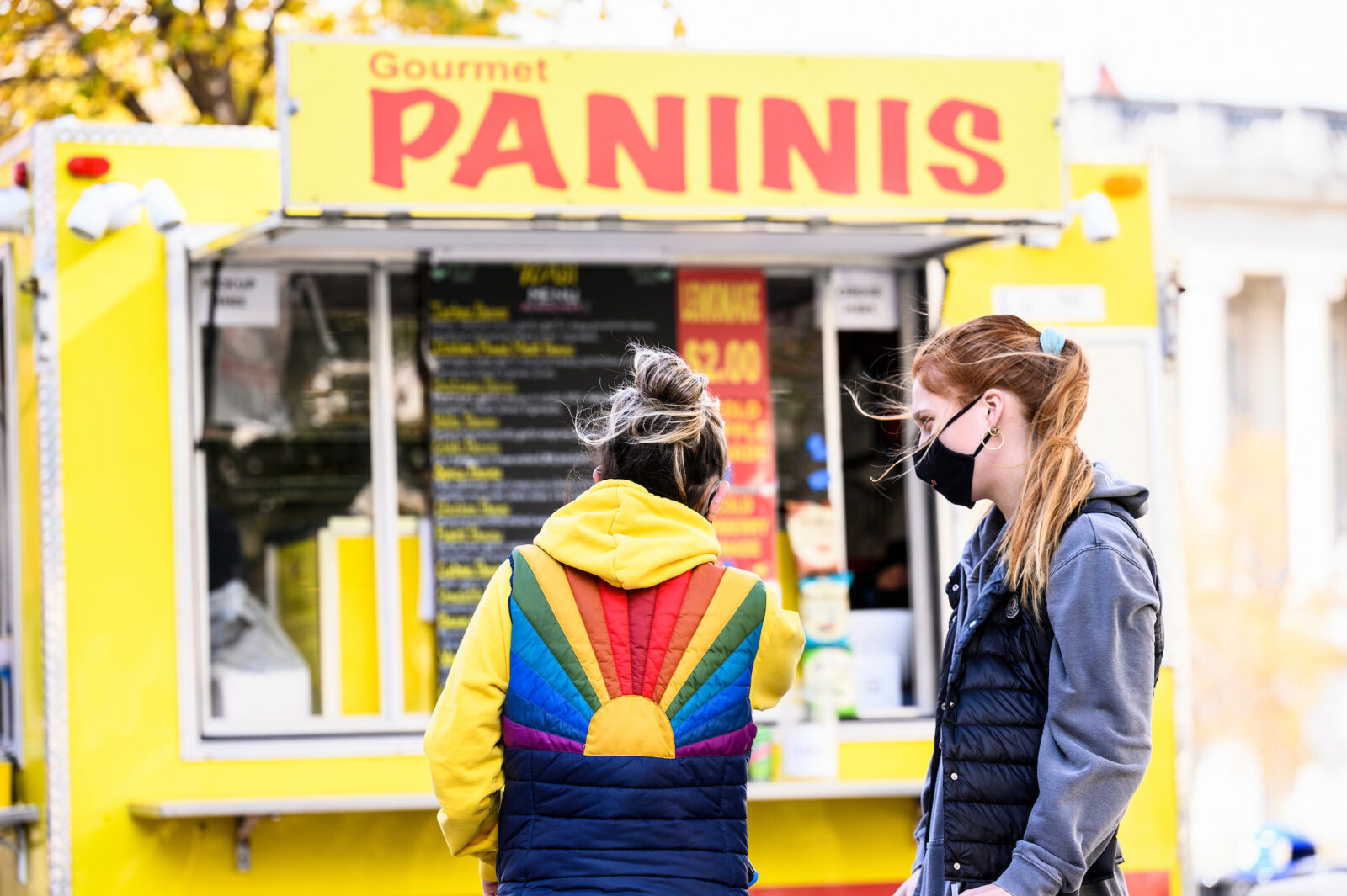 Students and pedestrians walk among the food carts on Library Mall during the first morning of classes for the Fall semester on Sept. 8, 2021. A campus health mandate requires people to wear face mask indoors – except while eating or drinking – as the coronavirus (COVID-19) pandemic continues. Face coverings are not required while outdoors. (Photo by Bryce Richter / UW-Madison)