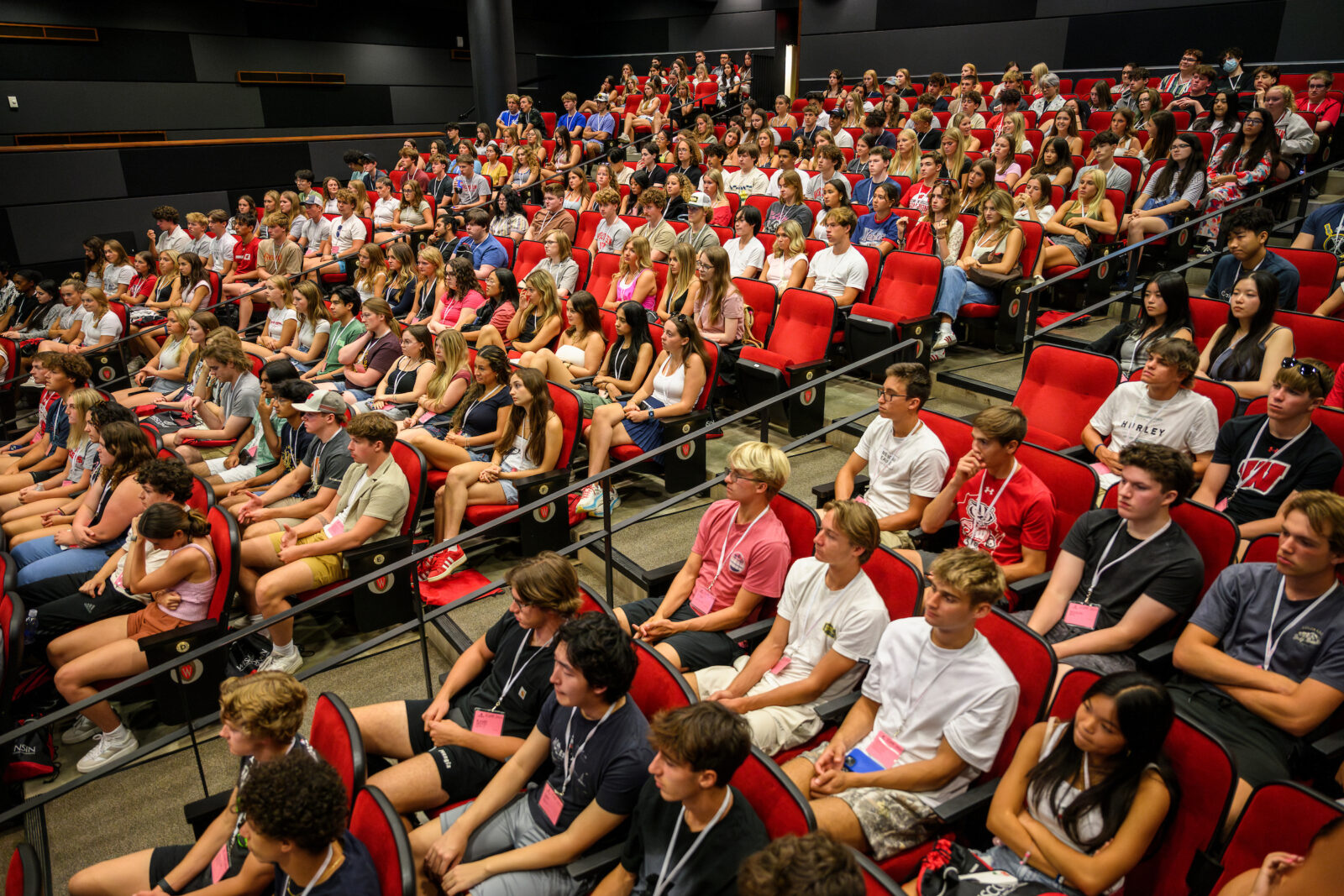 First-year students listen to a presentation during for the Student Orientation, Advising and Registration (SOAR) program in the Marquee Theater in Union South at the University of Wisconsin–Madison on July 30, 2024. Coordinated by the Office of Student Transition and Family Engagement, the two-day SOAR sessions provide new students and their parents and guests opportunities to learn about campus resources, connect with fellow first-year students, meet with advisors, register for classes, and explore campus. (Photo by Althea Dotzour / UW–Madison)