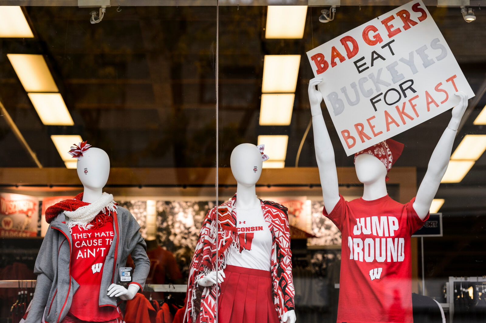 Wisconsin-themed attire and pro-badger signs are displayed in a University Book Store window before the start of a football game between the Wisconsin Badgers and the Ohio State University (OSU) Buckeyes at Camp Randall Stadium at the University of Wisconsin-Madison on Oct. 15, 2016. (Photo by Jeff Miller/UW-Madison)